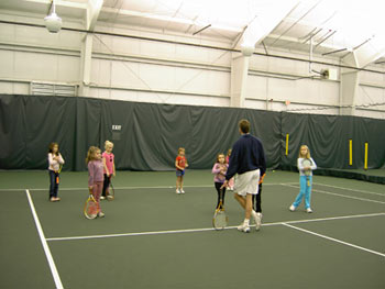 Director Michael Myers leading a junior group clinic session at the Enfield Tennis Club
